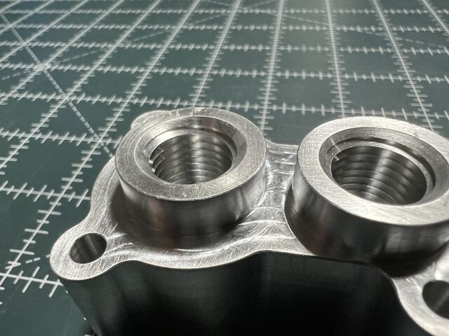 Aluminum manifold with threaded ports